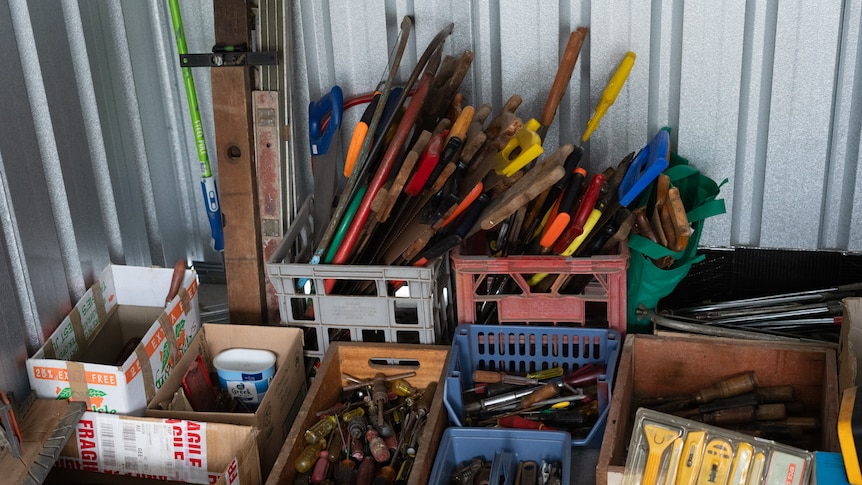 a pile of hand tools in a shed