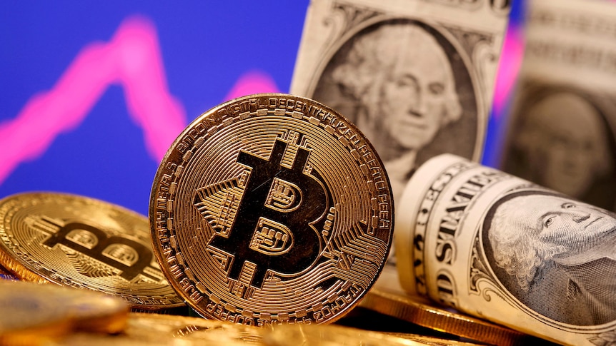A representation of virtual currency Bitcoin and US banknotes.