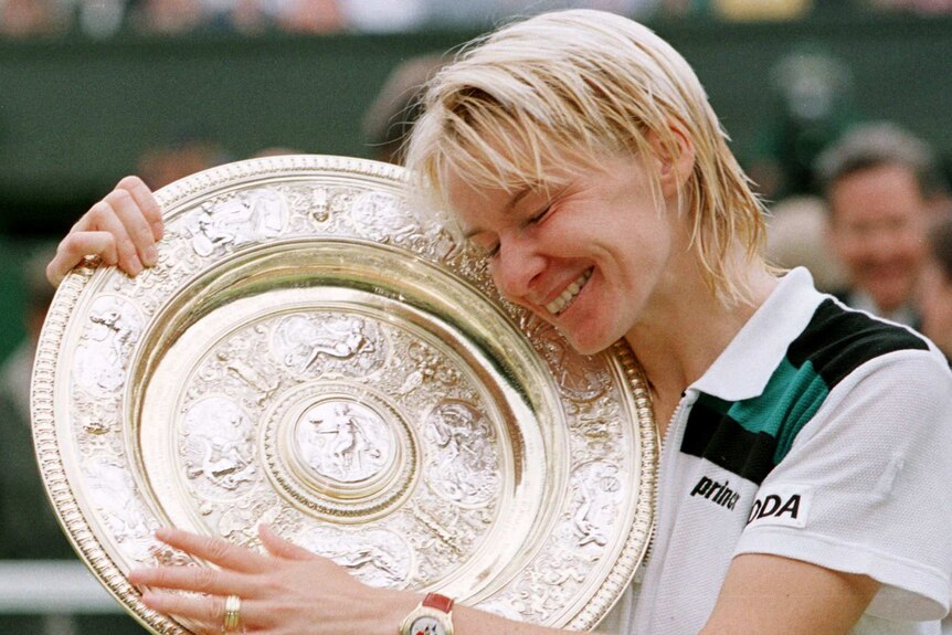 Jana Novotona hugging the Wimbledon trophy in 1998 following her win in the final.