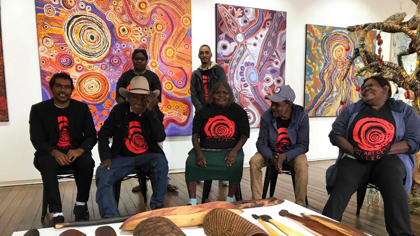 A group of Indigenous artists dressed in black showcase their work in Sydney.
