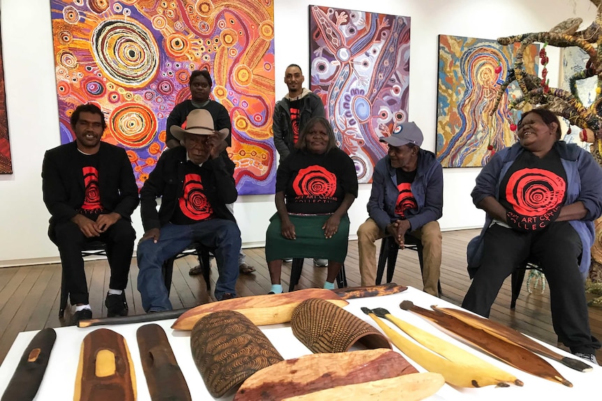 A group of Indigenous artists dressed in black showcase their work in Sydney.