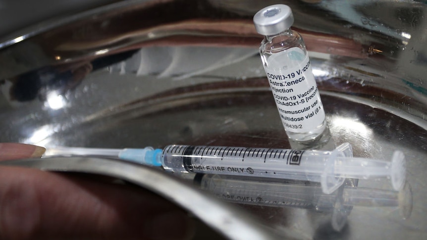 Syringe of Astra Zeneca vaccination in a bowl