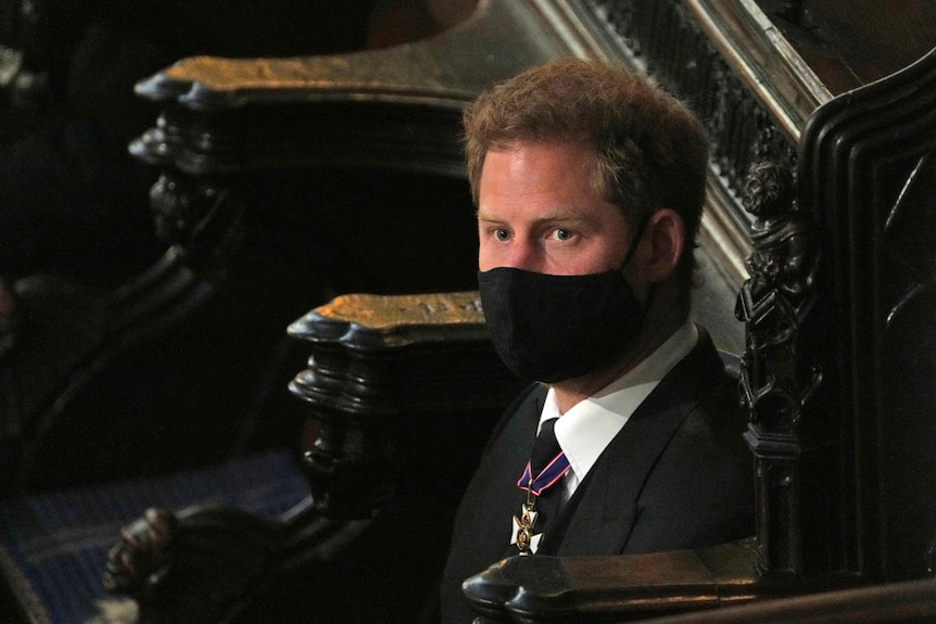 Prince Harry wears a black face mask during the funeral for Prince Philip.