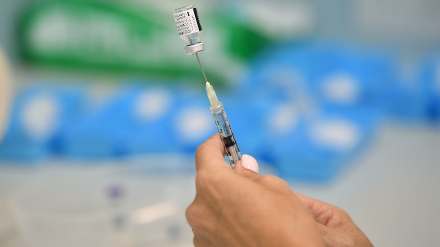 woman's hands holding an injection 