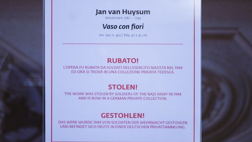 A sign saying the artwork was stolen by German Nazi soldiers in 1944