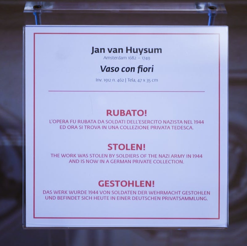 A sign saying the artwork was stolen by German Nazi soldiers in 1944