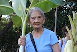 An old woman with banana leaves.
