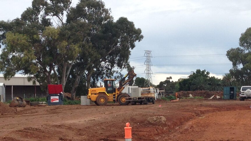 Police have gone to Parafield Gardens after workers dug up remains at a site in Kingborn Road.