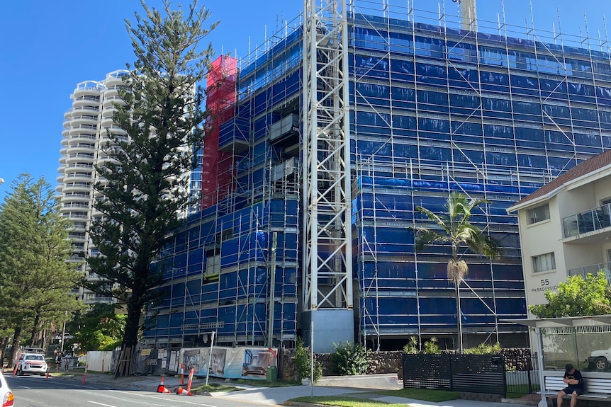 An empty building site surrounded by scaffolding