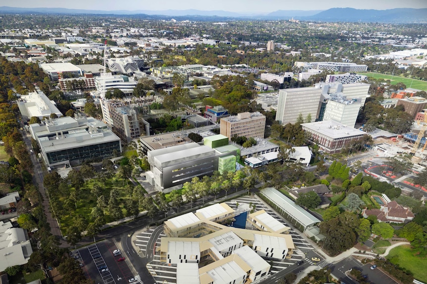 A birds-eye-view of Monash's Clayton campus, with rolling green hills in the background.