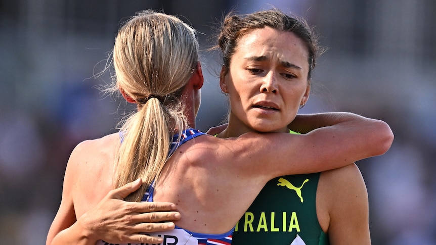 A British female 800m runner hugs an Australian rival at World Athletics Championships.
