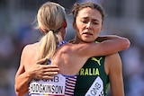 A British female 800m runner hugs an Australian rival at World Athletics Championships.
