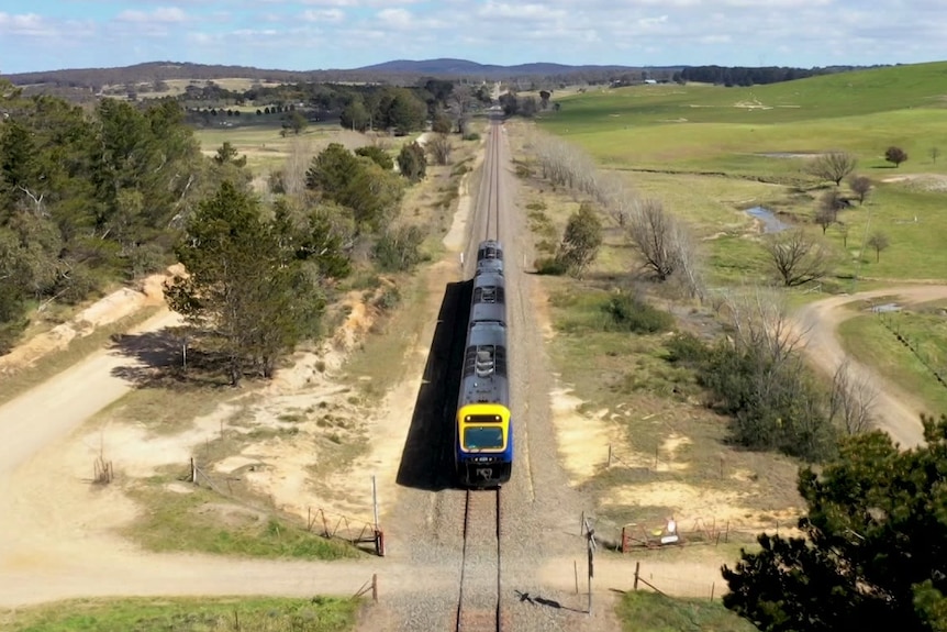 A commuter train moving along the tracks.