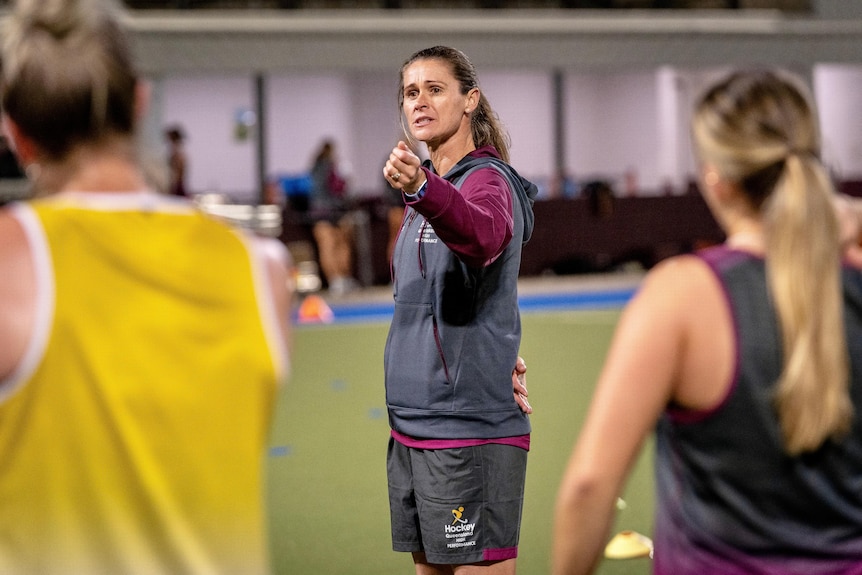 Olympic gold medallist Angie Lambert speaks to her players.