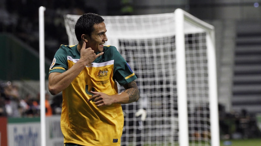Cahill phones home: Tim Cahill scores twice and pays tribute to the victims of Queensland's floods.