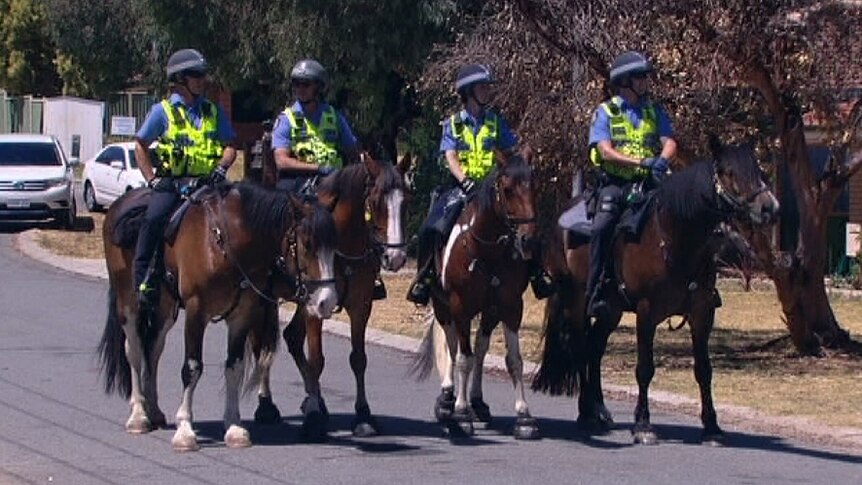 WA Police on horses patrol a Beaconsfield street