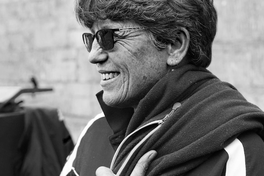 A black and white portrait of Jills Angus Burney holding a fleece over her shoulder.