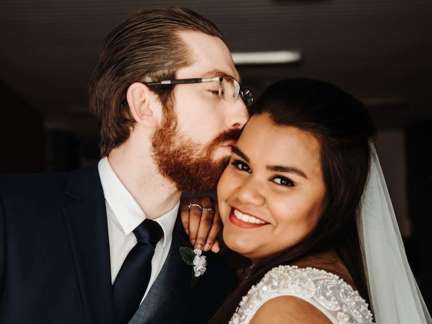 Andrew kisses Silvia on the head on their wedding day.