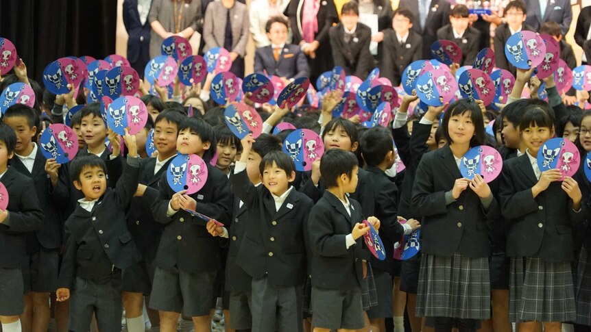 Japanese school children select Olympic mascots.