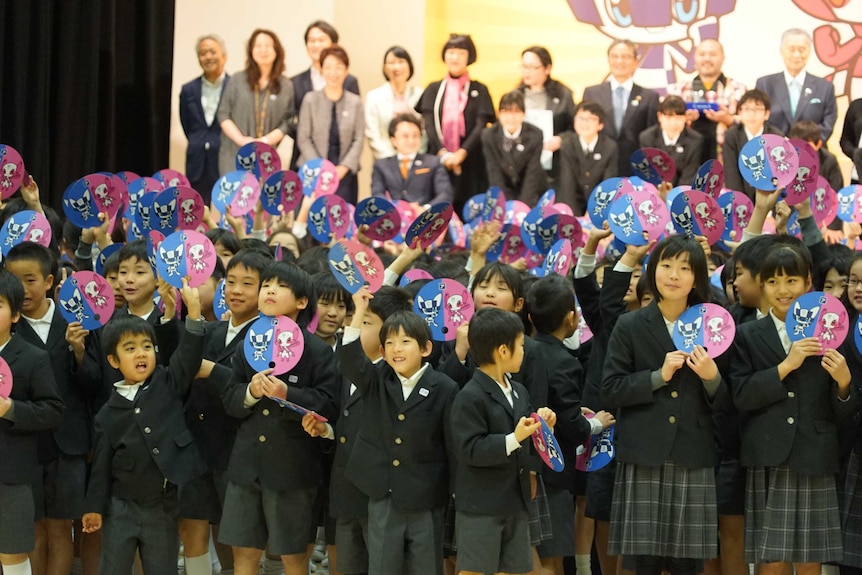 Japanese school children select Olympic mascots.
