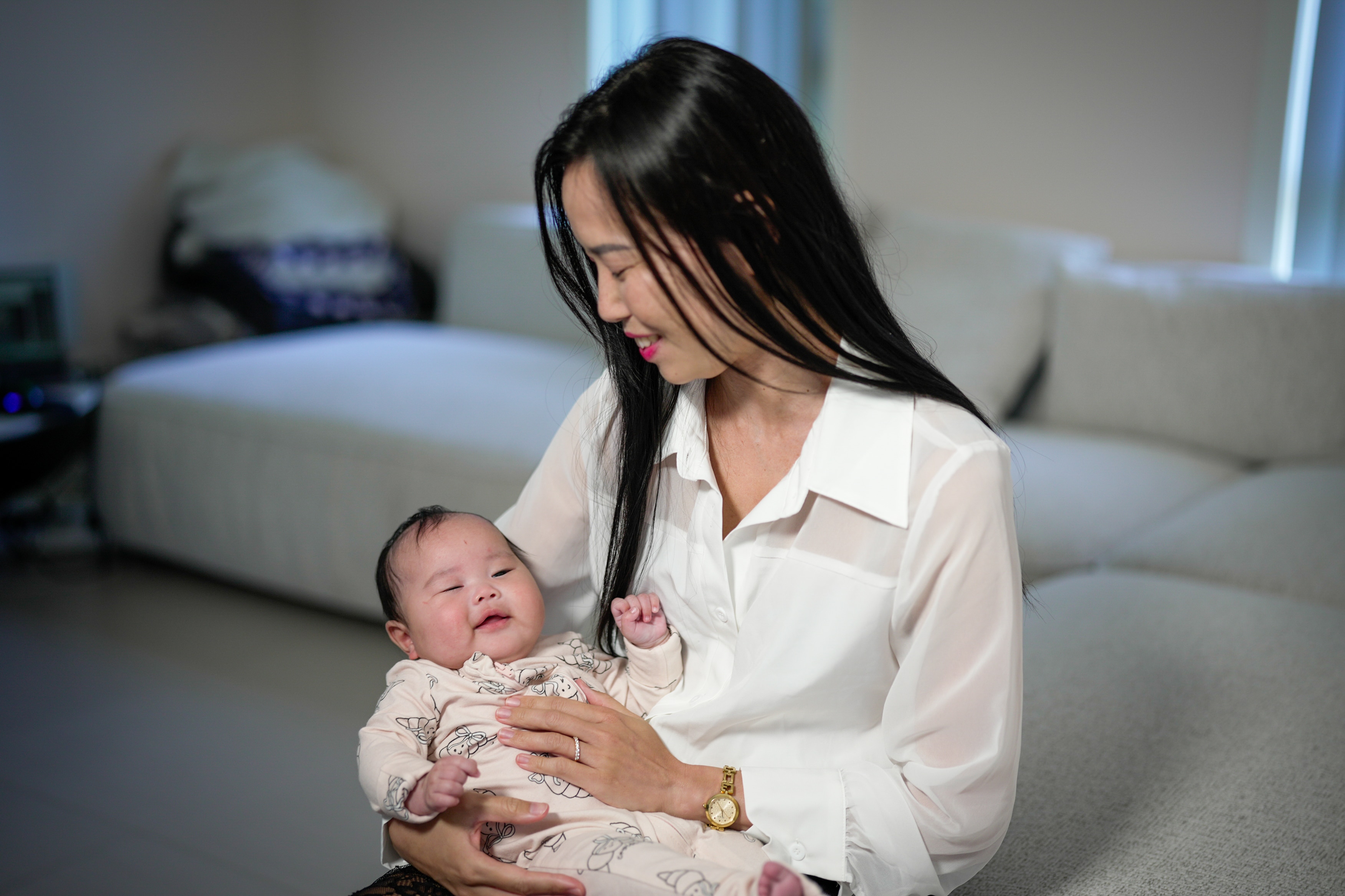 A woman holding her small baby. 