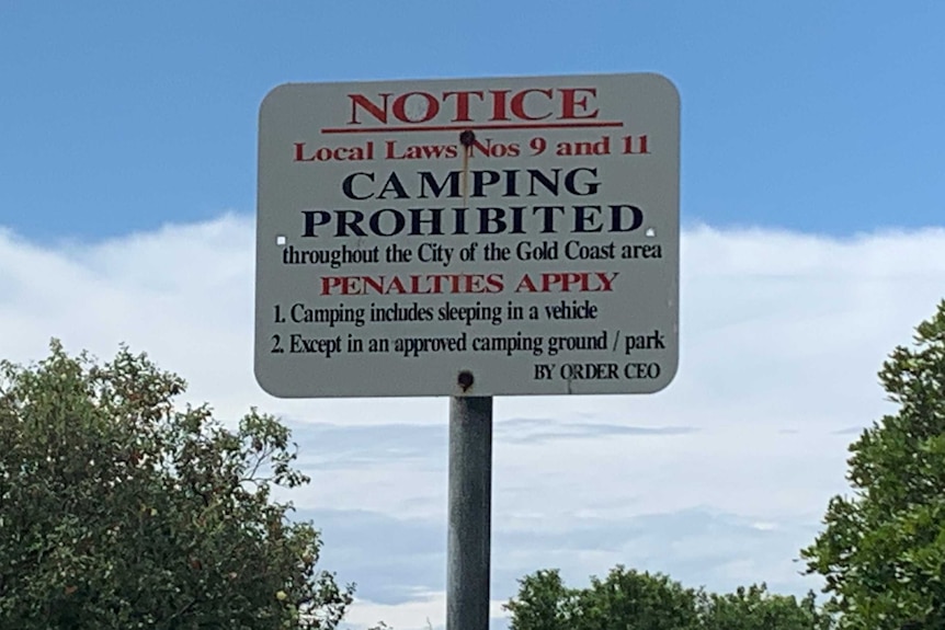 A sign reads Notice, Camping Prohibited