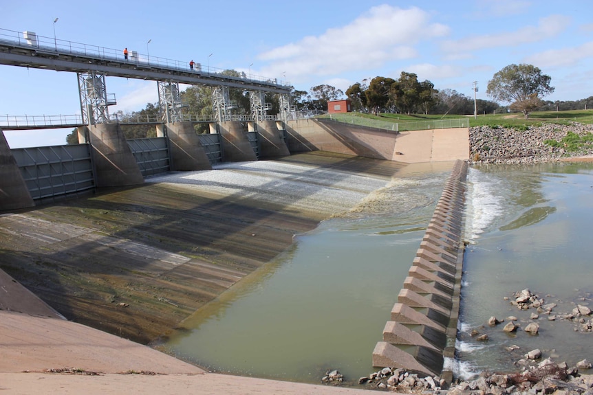 Water flows from the walls of a weir.