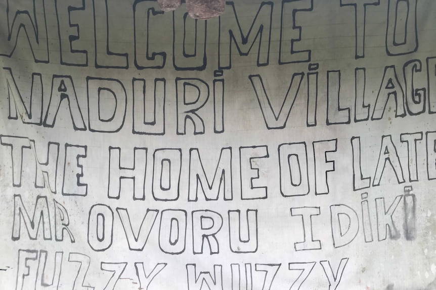 A sign saying 'welcome to Naduri Village, the home of late Mr Ovoru Idiki Fuzzy Wuzzy'.