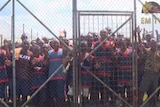 Prisoners behind a fence at the Buimo jail in PNG.