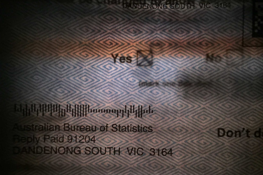 A torch light shines through an envelope to reveal a same-sex marriage postal vote form. The Yes box is marked with an X