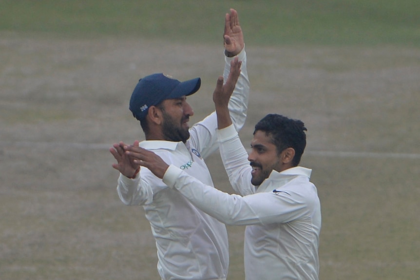 Ravindra Jadeja high-fives Cheteshwar Pujara