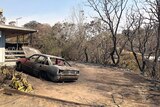 Burnt out car and part of house at Mount Larcom in central Queensland after bushfires in the area.