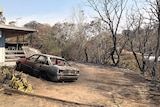 Burnt out car and part of house at Mount Larcom in central Queensland after bushfires in the area.