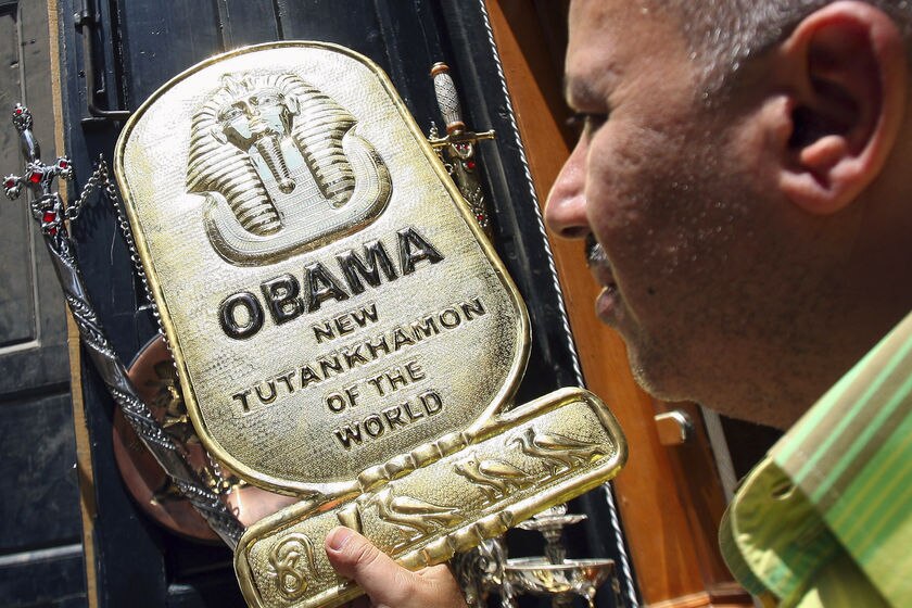 A souvenir shop owner displays a metal plaque in Cairo ahead of US President Barack Obama's planned speech on June 1, 2009.