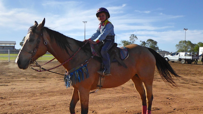 Seven year old barrel racing rider Charlie-Rose Prow and her Buckskin horse Mousse.