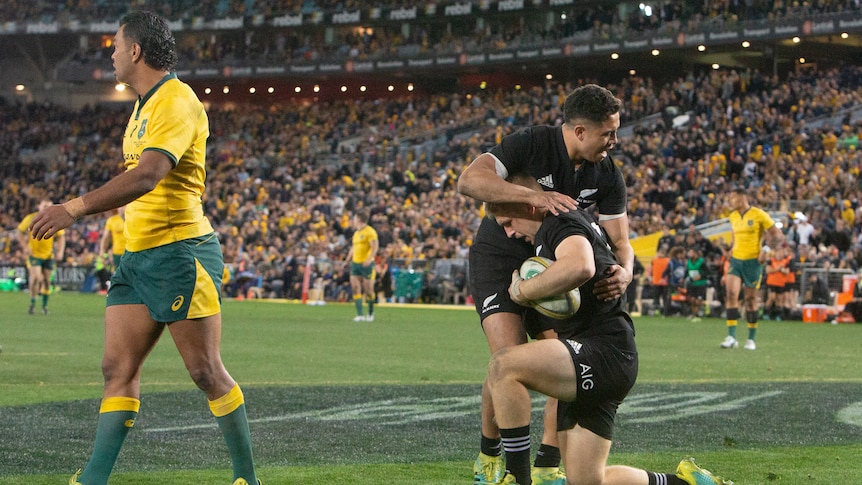 Jack Goodhue and Anton Leinart-Brown celebrate a try for the All Blacks against the Wallabies.