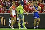 Swans' Callum Mills speaks to umpire Brendan Hosking after Bulldogs' Liam Picken was awarded a free kick