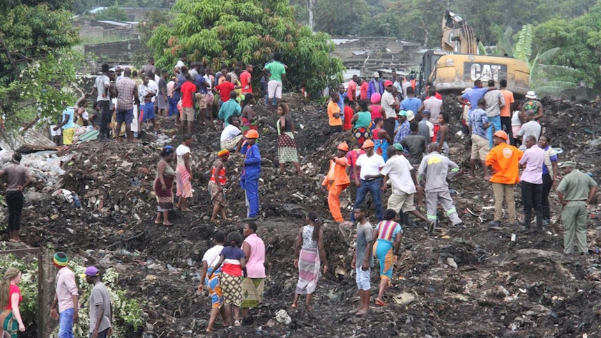 Rescuers search for survivors after the collapse of a garbage mound