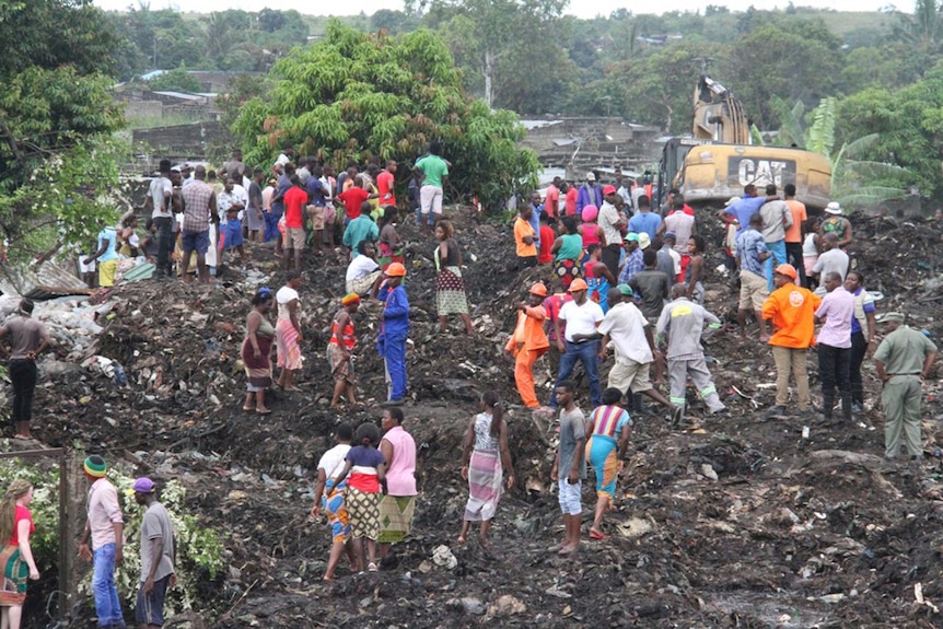 Rescuers search for survivors after the collapse of a garbage mound