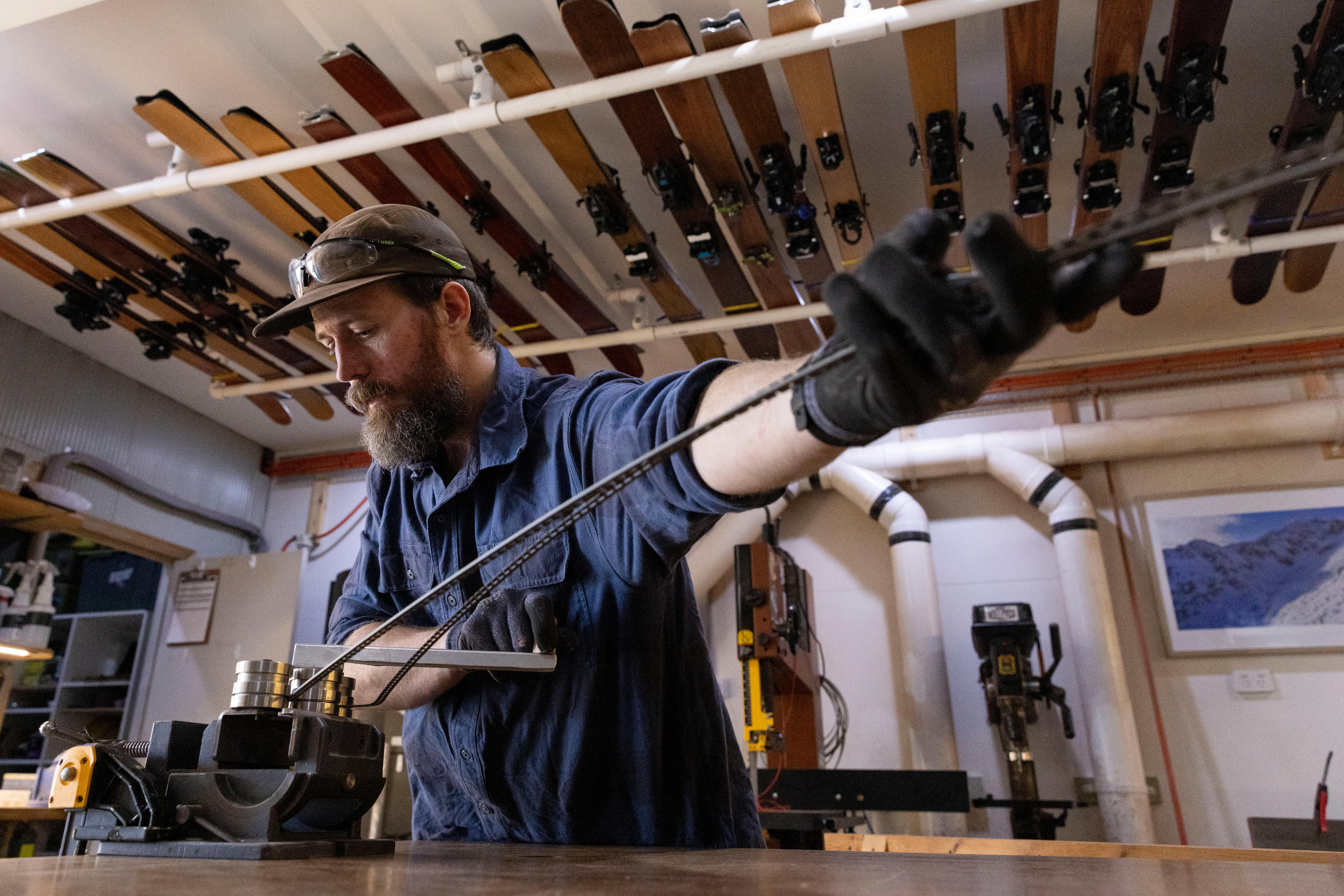 A man manufacturing bending metal in a workshop. 
