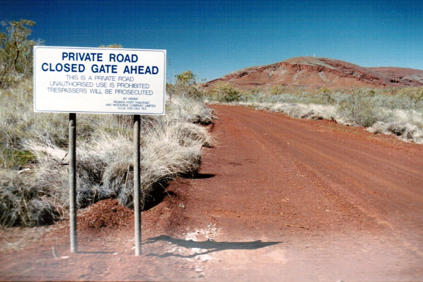 A dirt road leads to a ridge in the distance.