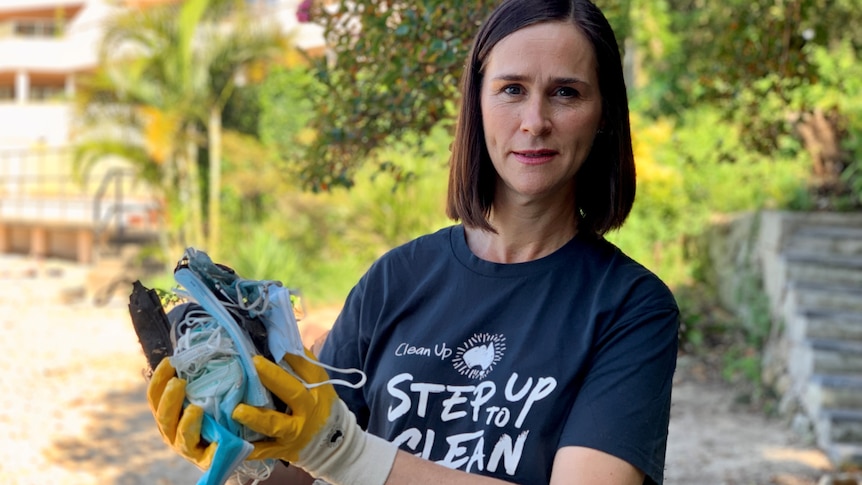 Pis Kiernan wearing gloves and holding rubbish.