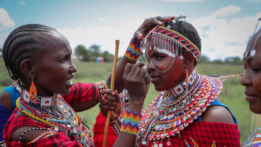 Women adjusting their outfits in Kenya