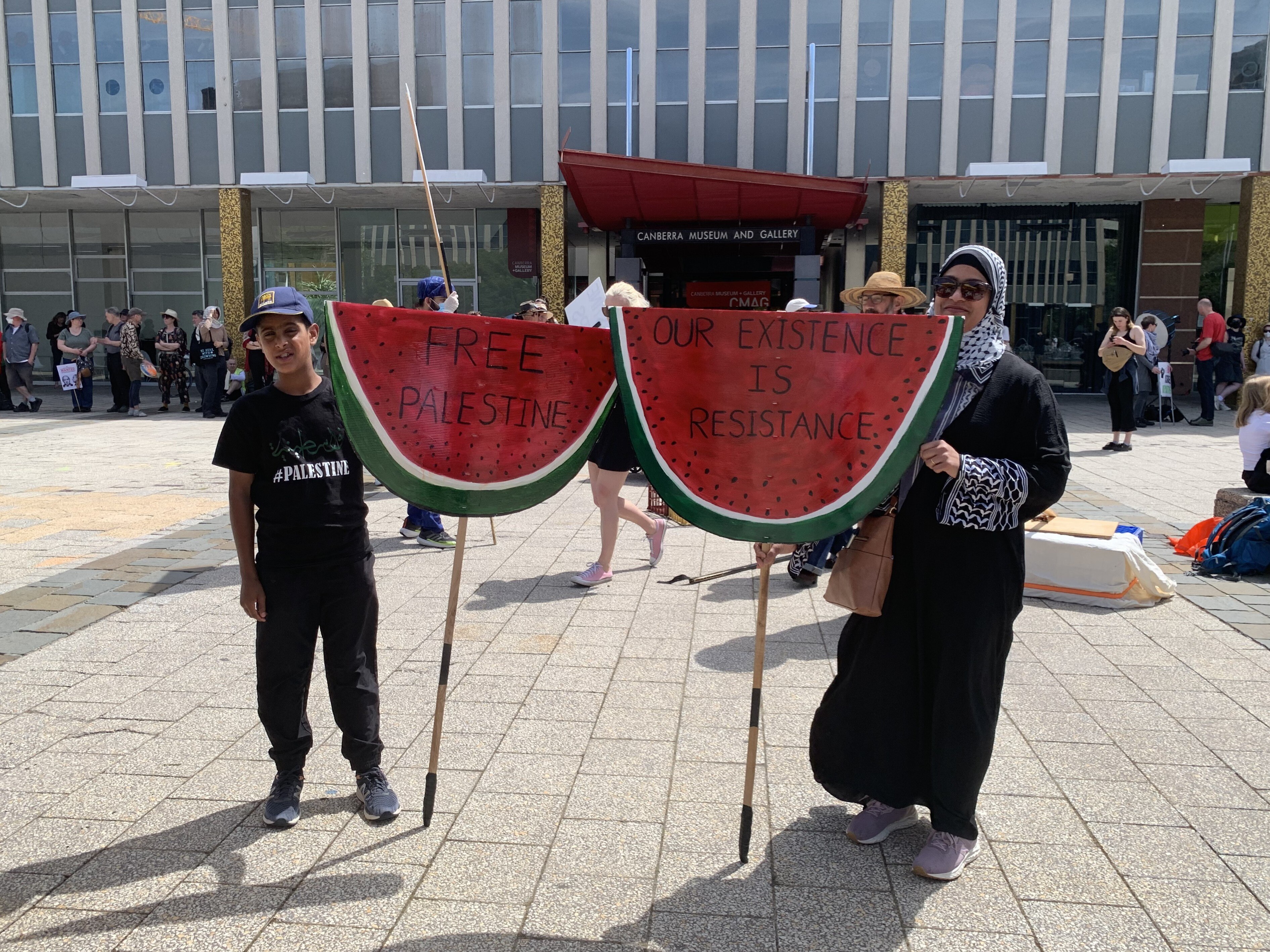 People holding 'Free Palestine' signs. 