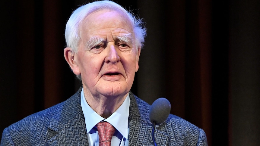John Le Carré in a suit speaks after receiving Olof Palme Prize at a ceremony in Sweden