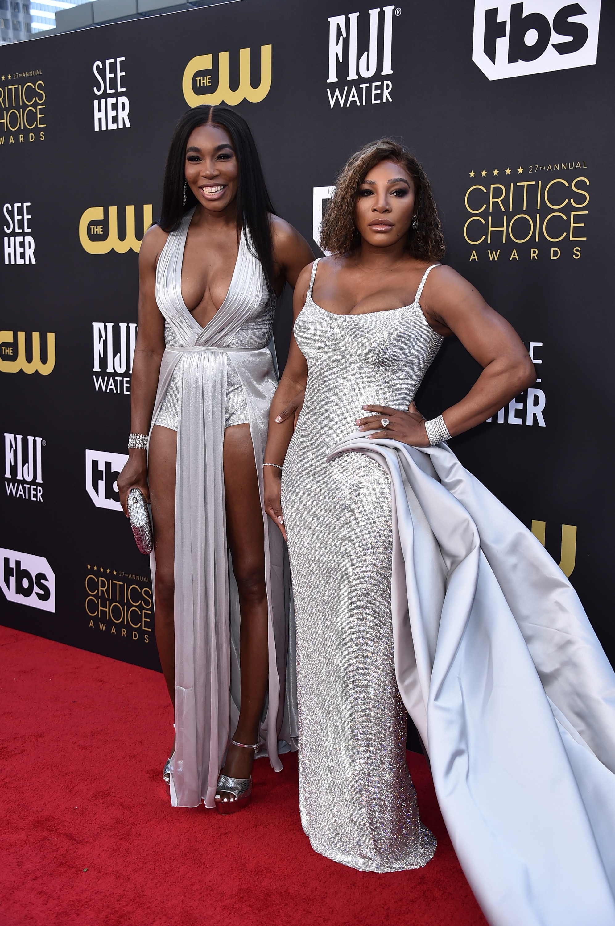 Venus Williams and Serena Williams pose on a red carpet