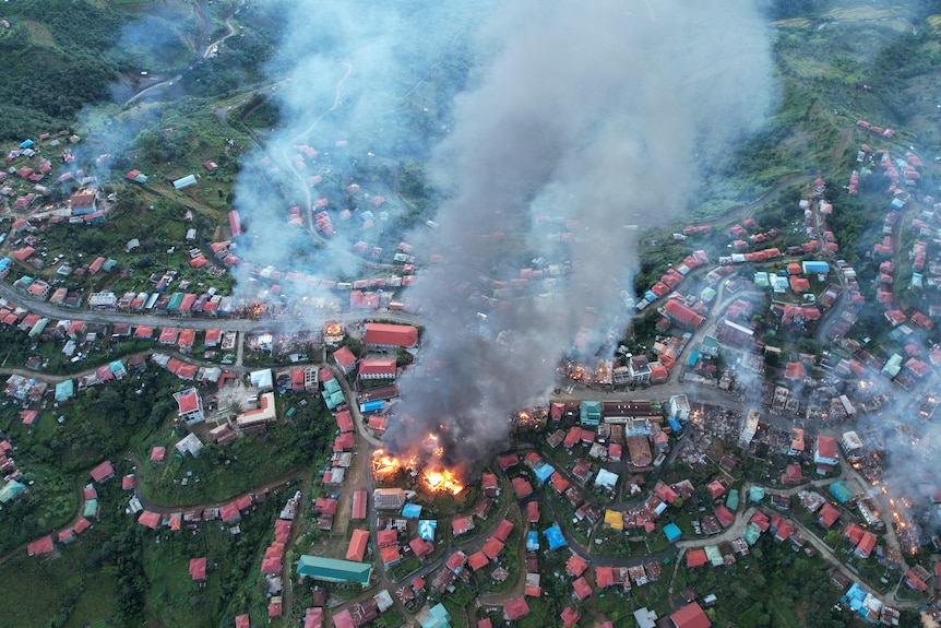 An areial shot of homes burning.