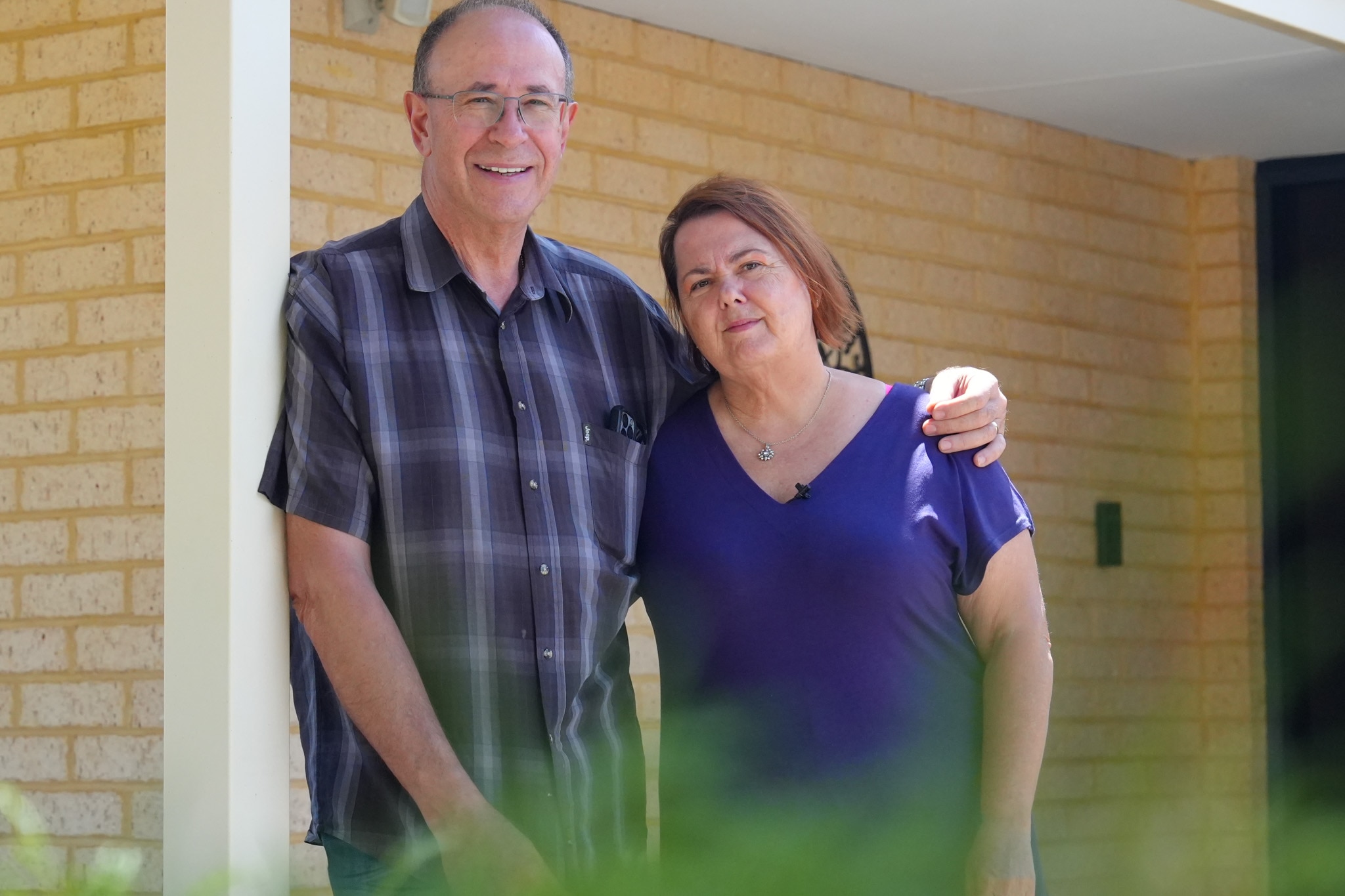 Mark coloca o braço em volta de Kay enquanto eles estão do lado de fora da casa dela.