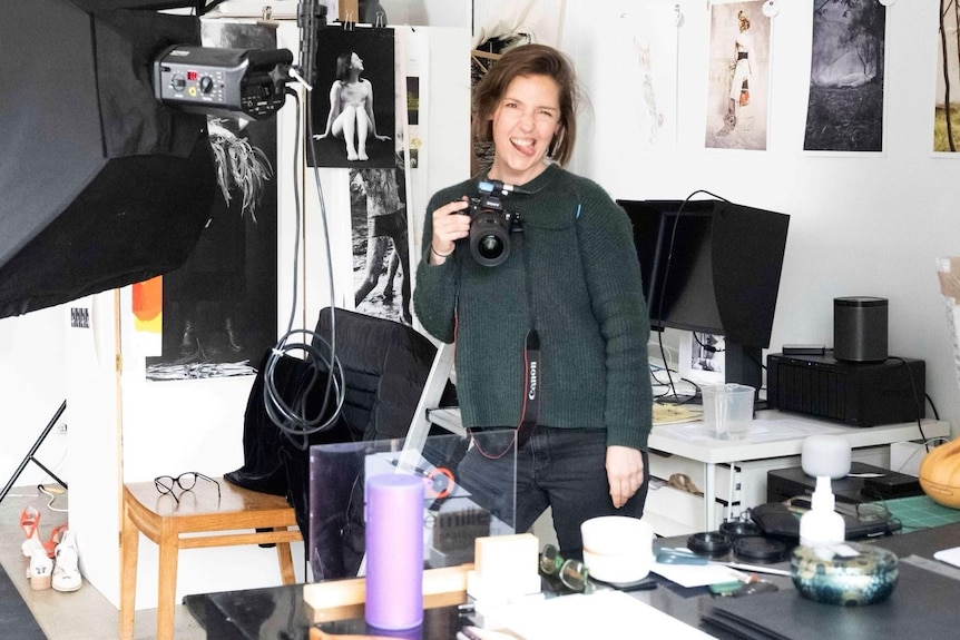 A woman with a camera in a studio 
