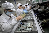 Chinese workers assemble electronic components at the Taiwanese technology giant Foxconn's factory in Shenzhen.